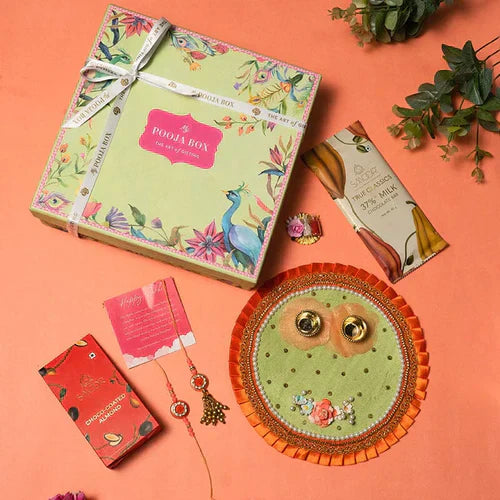 Rakhi gift box with a thali, small packet of roli and akshat, pair of rakhi, chocolates