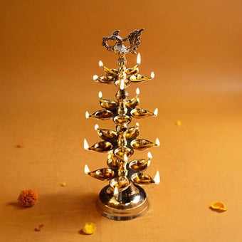 Brass oil lamp with multiple oil lamps on an orange background