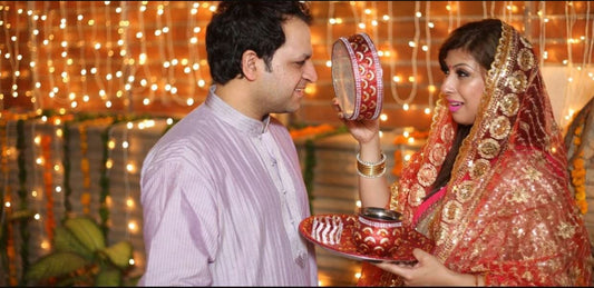 Husband wife performing karwa chauth rituals