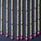 Decorative garlands with pink heart-shaped beads on a dark background