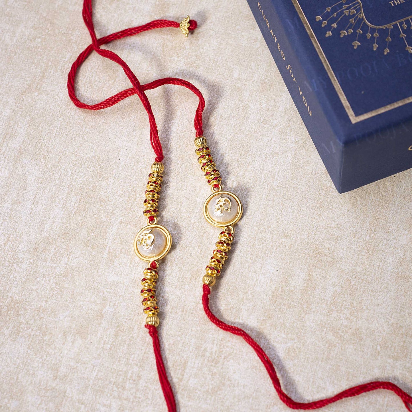 'Om' Opalescent Rakhi (Set of 2)